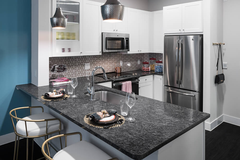 Alexan ross matte white multi family kitchen cabinets with steel grey quartz countertops